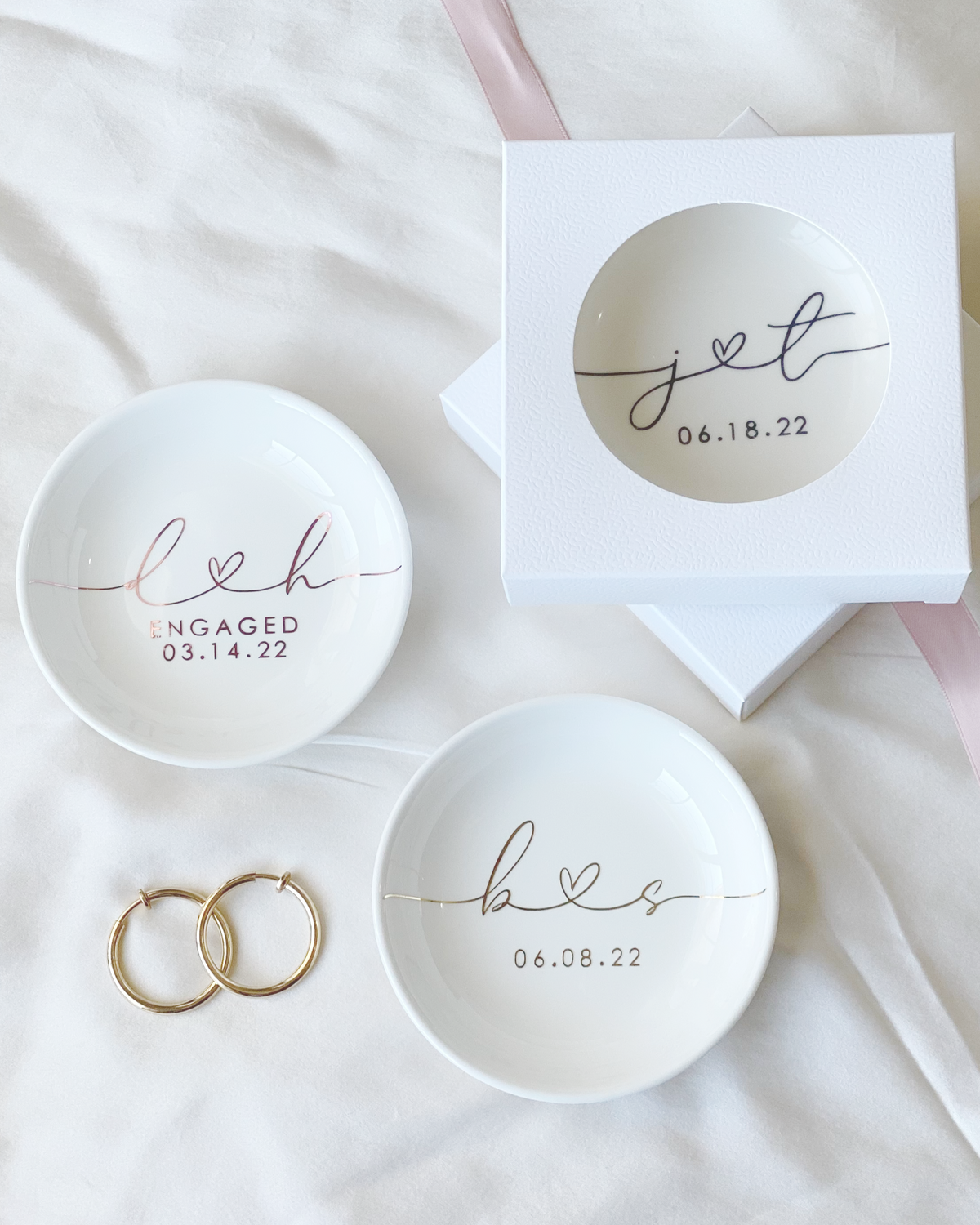 Personalized engagement ring dish with custom initials connected with a heart and date in black, gold, silver, or rose gold vinyl